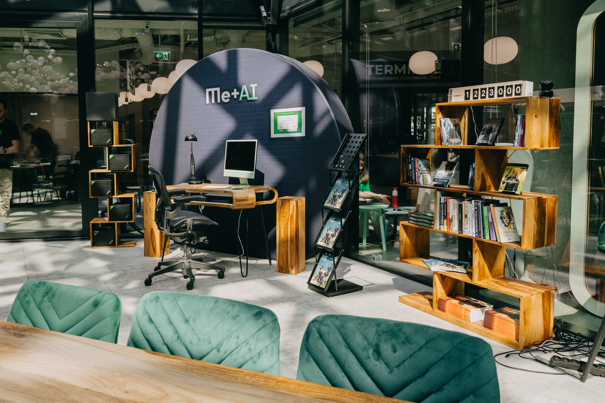 CampusAI showroom in Warsaw featuring Me+AI branded workspace with modern furniture, bookshelves, and collaborative areas